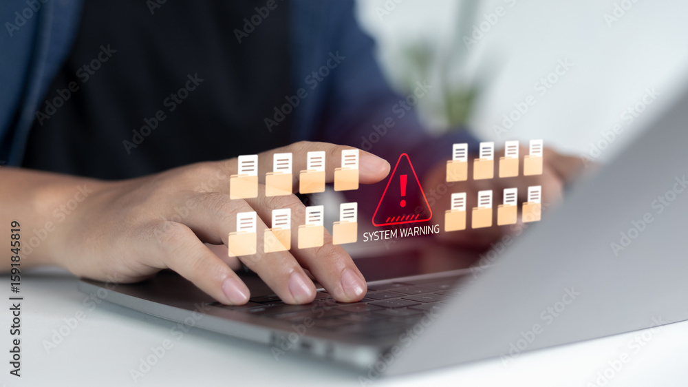 Aufkleber close-up hands typing laptop with warning alert icon and many file folders, concept of data breach, 
