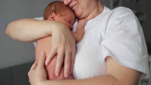 Grandmother holding newborn baby, pooping accident
