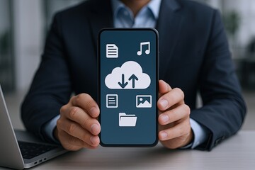 Businessperson holding smartphone displaying cloud storage and multimedia icons on screen.