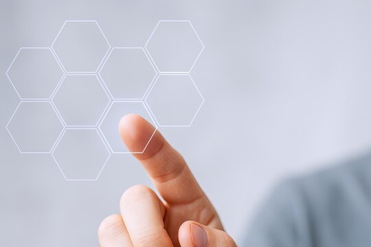 Person interacting with futuristic digital interface showing holographic hexagonal grid.