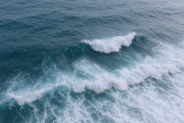 Fototapeta premium Aerial view of ocean waves crashing with foamy white surf in deep blue sea nature scene.