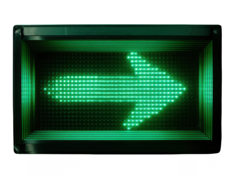A green led traffic arrow sign illuminated against a dark background directing to the right