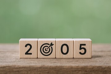 Wooden blocks displaying the year 2005 with a target symbol for goal achievement.