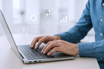 Person Using Laptop with Digital Data and Analytics Icons Floating in Modern Workspace.
