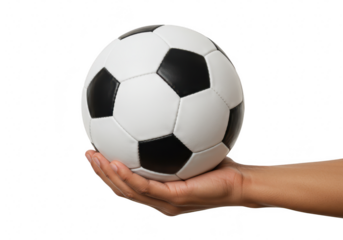 A persons hand gently holding a classic black and white soccer ball, isolated on a transparent background