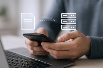 Person Using Smartphone for Data Transfer and Cloud Backup with Laptop and Cloud Icon.