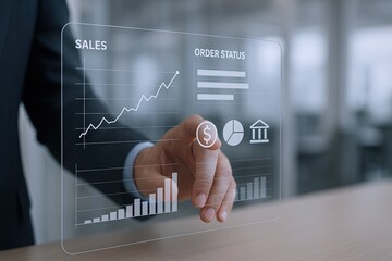 Business professional interacting with transparent digital data visualization of sales and growth.