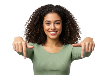 A young woman with curly black hair smiles and points down, isolated on transparent background