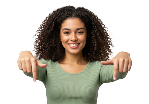 A young woman with curly black hair smiles and points down, isolated on transparent background