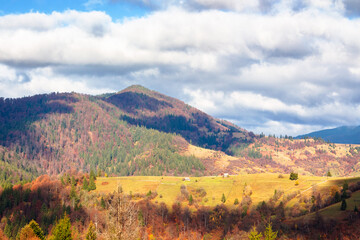 beautiful mountain countryside landscape in autumn. sky with clouds. scenic view of alpine...