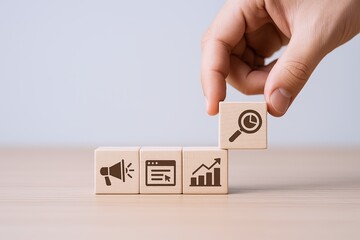 Hand Placing Square Block with Analytics Icon on Top of Row of Business Growth Blocks.