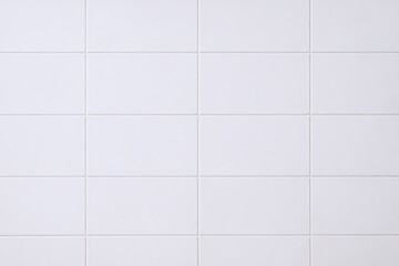 Minimalist white ceramic tiled wall with clean lines and subtle grid pattern.