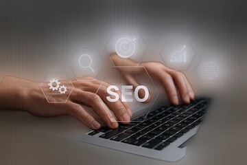 Expert hand typing on laptop keyboard displaying SEO and digital marketing icons.