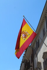 Spain or Spanish flag waving in the wind on a building 