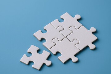 Simple white puzzle pieces fitting together on a bright blue background for teamwork.