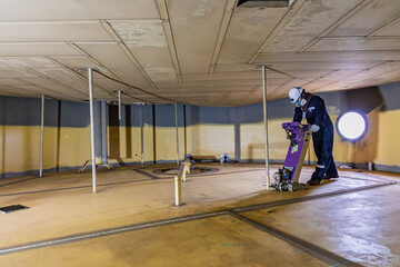 Male worker inspection floorscan tank wall, lose corrosion, soil side bottom plate tank inside...