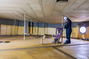 Male worker inspection floorscan tank wall, lose corrosion, soil side bottom plate tank inside...