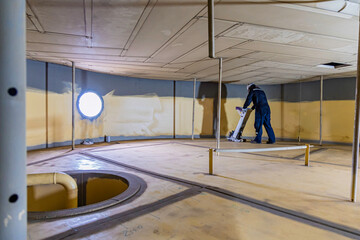 Male worker inspection floorscan tank wall, lose corrosion, soil side bottom plate tank inside...