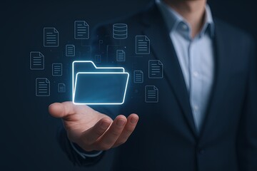 Businessman in suit holding glowing digital folder with documents and data icons.