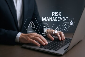 Businessman Pointing at Digital Risk Management Icons on Laptop Screen in Office.