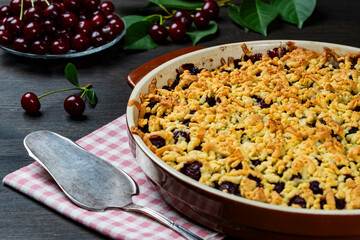 Baking dish with tasty cherry pie, closeup. Delicious homemade pie with fresh red cherries on...