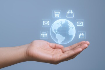 Fototapeta premium Modern digital technology concept with a hand holding a glowing globe surrounded by shopping, email, home, and security icons.