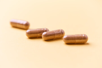 Carnitine capsules. Concept for a healthy dietary supplementation. Bright paper background. Soft focus. Close up.	