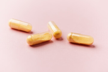 Coenzyme Q10 capsules. Antioxidants. Concept for a healthy dietary supplementation. Bright paper background. Soft focus. Close up. Copy space.	