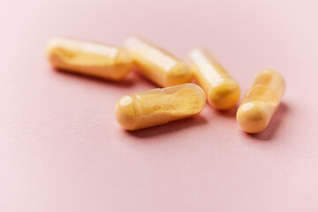 Coenzyme Q10 capsules. Antioxidants. Concept for a healthy dietary supplementation. Bright paper background. Soft focus. Close up. Copy space.	