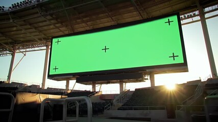 Empty Stadium Scoreboard with Green Screen Mockup at Sunset, Ready for Digital Content Insertion and Advertising Display