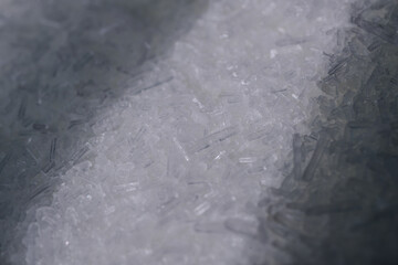 This macro photograph captures the intricate details of MSG (monosodium glutamate) crystals. The...
