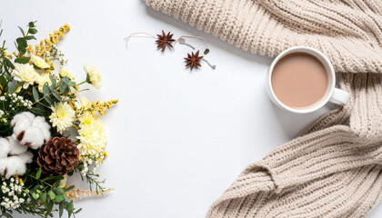 against a crisp white backdrop, a curated scene unfolds with elements evoking warmth and comfort. a bouquet of blooms, including white flowers, greenery, and cotton, sits nestled together