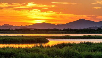 Colorful sunset over a tranquil lake and mountains