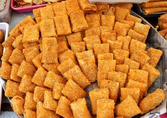 Delicious and warm stuffed risoles are being sold at a traditional snack stall. Risoles is a traditional Indonesian food that can be filled with chicken, vegetables, meat, corn, and mayonnaise.