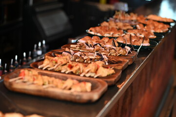 Stylish catering spread with skewered appetizers on wooden boards