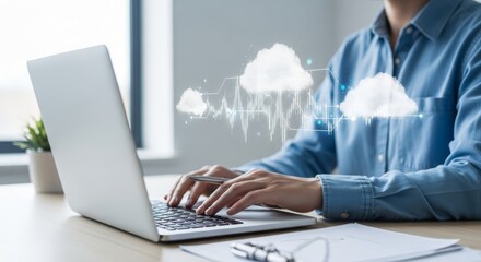 Professional using laptop with cloud computing interface.