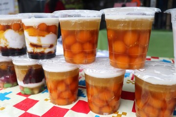 Biji salak is a traditional Indonesian dessert made from sago flour and purple sweet potatoes, with a chewy and sweet texture. It is commonly served with bubur sumsum, a soft rice flour pudding.