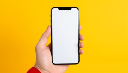 Hand holding a smartphone with a blank screen against a vibrant yellow background
