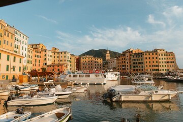 Colorful buildings overlooking boats in porto venere, italy, at sunset