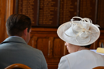 People waiting at a wedding, dressed beautifully