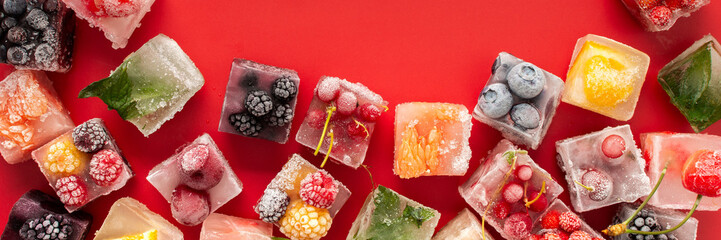 Ice cubes with frozen berries and fruits © pundapanda