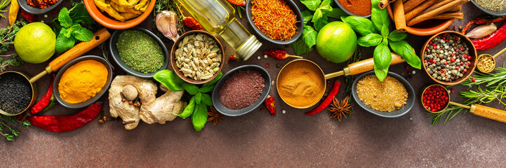 A rich palette of colorful spices and herbs, resting on a brown background, radiating freshness and an inviting aroma, perfect for gourmet inspiration, banner