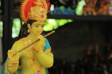 Hindu God Krishna playing flute, dark background, Indian mythology, spirituality, divine deity.
