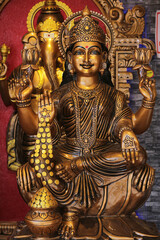 Bronze statue of Hindu goddess Lakshmi, traditional Indian deity of wealth and prosperity, spiritual sculpture for Diwali or puja worship.