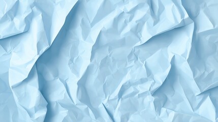 Obraz premium Crumpled pale blue wrapping paper creating soft textural background, providing gentle color gradient and wrinkled surface with subtle visual depth and artistic potential