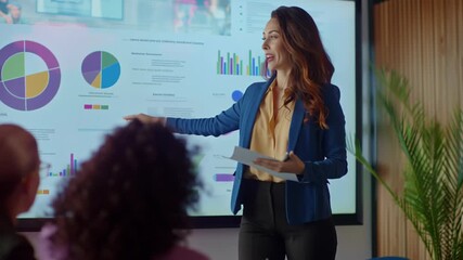 Businesswoman giving a presentation with charts and graphs in modern office setting - Powered by Adobe