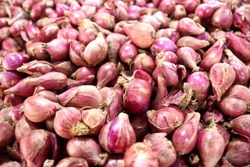 Fresh, mature red onion bulbs. Background of a bunch of red onions. Asian cooking spices.