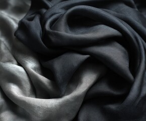 Fototapeta premium Elegant Textiles in Grayscale Abstract Composition Textured Cloth Displaying Soft Drapes, Shades of Black, Gray, and Silver Create a Dramatic Visual Appeal