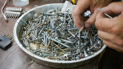 Sorting and finding the right screws and hardware in a tray demonstrates attention to detail and...