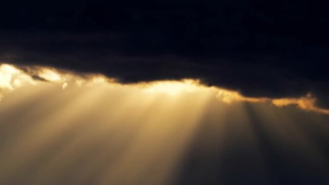Final rays of sunlight piercing through a narrowing gap in rapidly closing dark clouds. 
